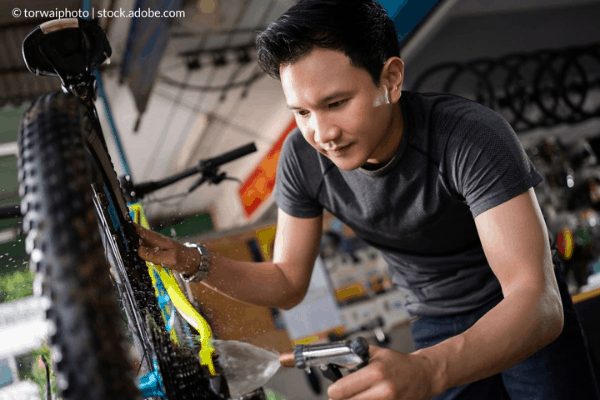 Applying degreaser to a brake rotor